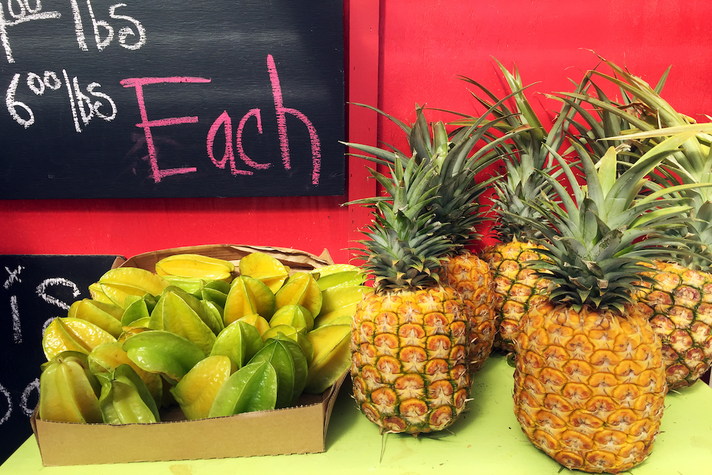 pineapples and papayas at farmers market, kauai market