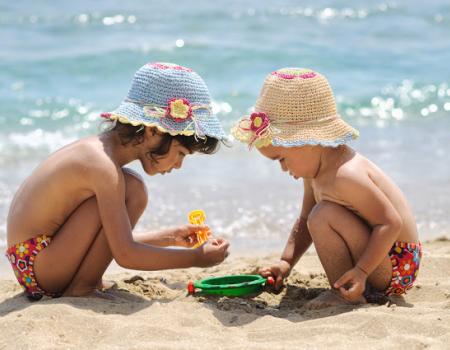 kids playing on beach in swim shorts