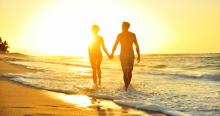 couple-walking-on-romantic-kauai-beack-at-sunset
